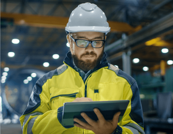 warehouse hardhat person using tablet